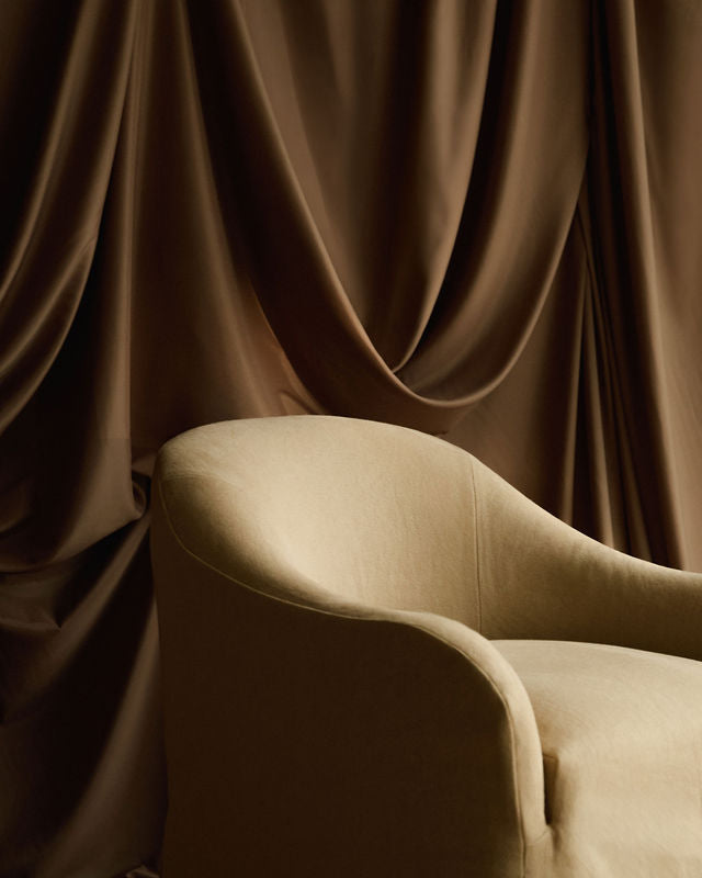 Close up detail of Ocra upholstered linen chair by Frances Jean in Chelsea furniture showroom 
